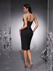 Elegant back view of black bandage dress featuring sparkling silver tassel straps