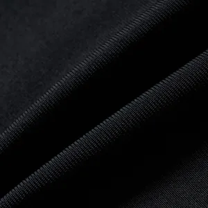 Close-up macro detail of premium black ribbed bandage fabric with high-stretch texture