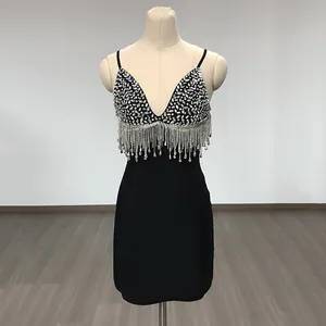 Detailed view of the sequined bodice and crystal fringe on a black bandage mini dress