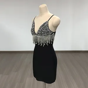 Detail view of a black bandage mini dress with silver sequins and rhinestone tassels.