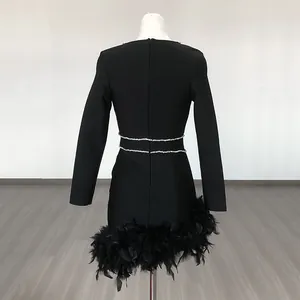 Back view of a black bandage mini dress featuring rhinestone waist and feather trim