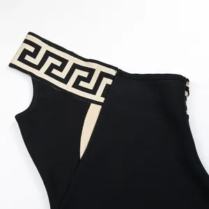 Close-up detail of a black one-shoulder bandage dress with elegant meander pattern strap
