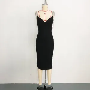 Detailed view of luxury rhinestone fringe straps on a classic black V-neck bandage midi dress