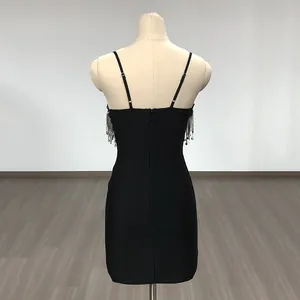 Back view of black bodycon mini dress with spaghetti straps and metallic fringe detail