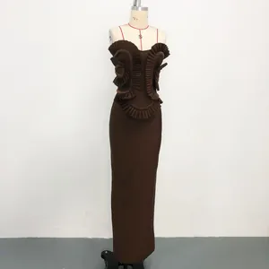 Detailed view of the symmetrical ruffles and handmade beading on this brown maxi dress.