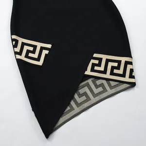 Close-up of black bandage dress featuring beige Greek key jacquard and asymmetric hem.