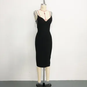 Detail of black bandage dress featuring heavy tassel rhinestone chain straps and V-neck.
