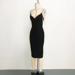 Detail view of black bandage dress featuring elegant rhinestone tassel shoulder straps.