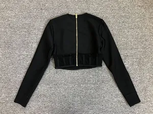Vue arrière du crop top noir à manches longues avec zip doré et détails de taille en mesh