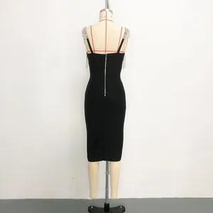 Back view of a black bandage bodycon dress with silver tassel rhinestone straps