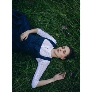 Elegant dark blue Dirndl with a white lace blouse for Oktoberfest Bavarian festivals.