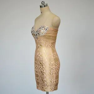 Detailed side profile of luxury gold-stamped strapless mini dress with sparkling rhinestones
