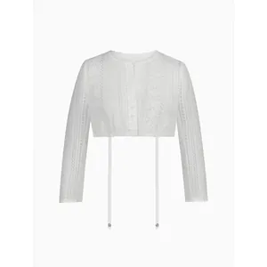 Detail showing the intricate floral lace texture and ribbon on this white Dirndl crop blouse
