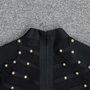 Close-up detail of a black bandage party dress with gold stud accents and mesh
