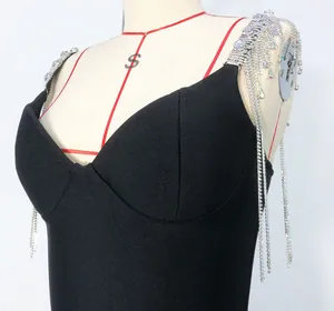 Detail shot of black bandage dress with sparkling rhinestone tassel shoulder straps.