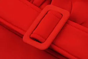 Close-up detail of red space cotton dress with matching fabric-covered belt buckle