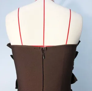 Close-up back detail of brown bandage dress with invisible zipper and ruffled edges