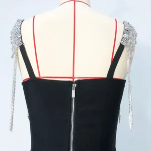 Close-up back detail of bandage dress with heavy rhinestone chain tassels and zipper