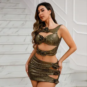 Close-up detail of a glamorous gold sequin two-piece set featuring cutouts and floral appliques