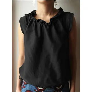 Close-up of black sleeveless cotton linen top with ruffled collar and tie hem detail