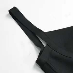 Close-up detail of black bandage jumpsuit straps and premium textured ribbed fabric.