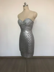 Detail showing luxury rhinestone embellishments on a silver strapless bandage party dress