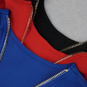 Detail shot of golden metal zippers on blue, red, and black ribbed bandage dresses