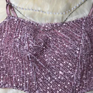 Close-up detail of shimmering pink sequins and elegant pearl-accented chain straps