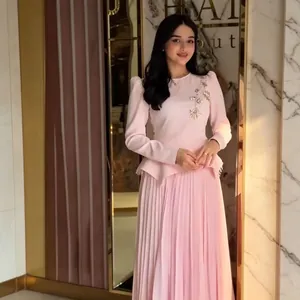 Elegant pink long-sleeved pleated dress with delicate floral shoulder embroidery