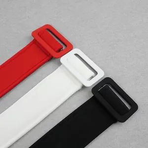 Detail view of wide space cotton waistbands in red, white, and black with large buckles.