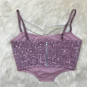 Detailed back view of a pink sequined crop top with pearl and metallic chain accents.