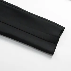 Detailed macro view showing the high-quality ribbed texture of a black bandage jumpsuit