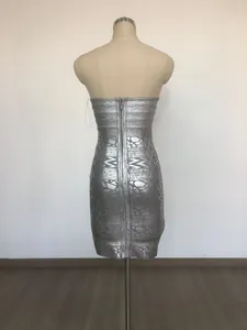 Back view of silver metallic bandage dress with geometric pattern and long zipper.