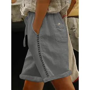 Close-up of casual grey women's shorts featuring delicate side lace hollow-out detail.