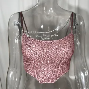 Close-up of pink sequined camisole featuring decorative pearl and silver chains for women.