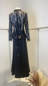 Back view of elegant black lace dress with corset tie and peplum waist detail