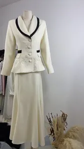 Detailed view of French style cream blazer and skirt suit with floral embroidery