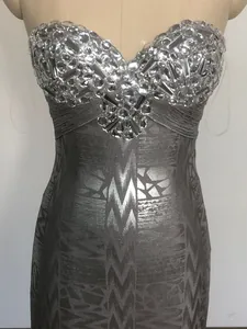 Detail of luxury rhinestone embellishments on a silver strapless bandage party dress