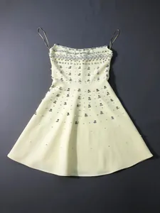 Elegant pale yellow mini party dress featuring heavy crystal and pearl embellishments
