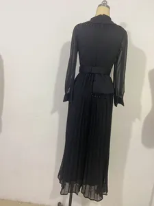 Detailed back view of a black pleated fashion set with beaded fringe and sheer long sleeves