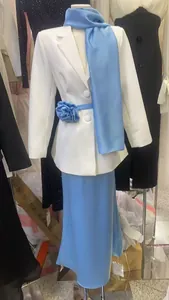 Elegant white blazer and blue maxi skirt set with floral belt detail