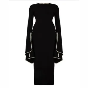 Elegant black long sleeve maxi evening dress with pearl trim detail around cuffs.