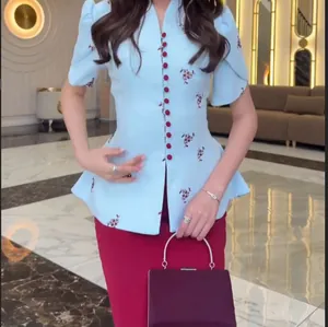 Detailed view of a light blue floral peplum top and red pencil skirt two-piece set