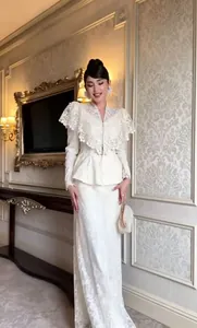 Full view of white V-neck lace shawl set with heavy floral embroidery in luxury setting
