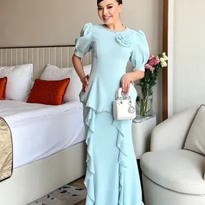 Full-length view of elegant light blue beaded peplum fishtail dress on model
