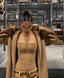 High stretch camel ruched mesh tube top for women in industrial fashion photoshoot