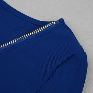 Macro view of the golden metal zipper detail on high-quality blue ribbed bandage fabric