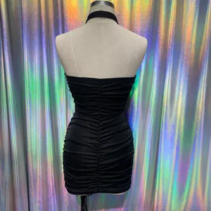 Rear view of a sexy black halter neck ruched bodycon mini dress displayed on a mannequin