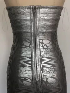 Back detail of silver metallic strapless bandage dress with geometric print and zipper.
