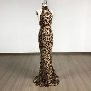 Detailed macro view of a leopard print sequin halter neck evening gown on a mannequin stand